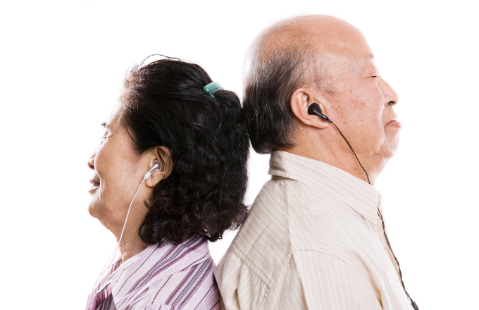 An isolated shot of a senior asian couple listening to music