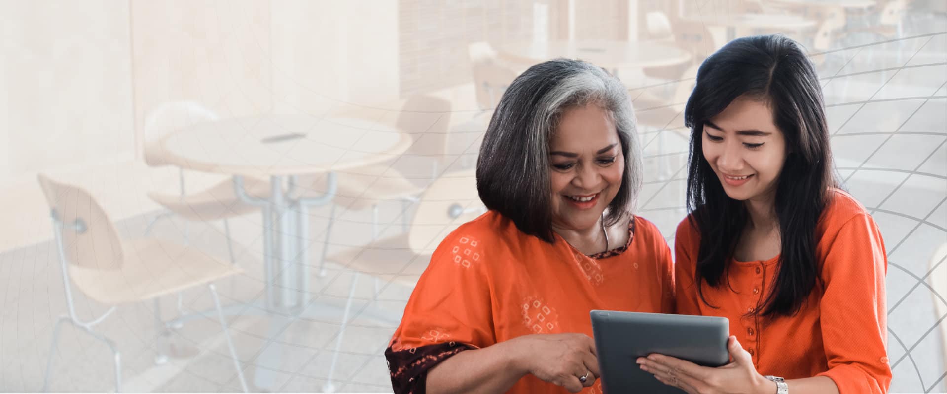 mother and daughter looking at the tablet